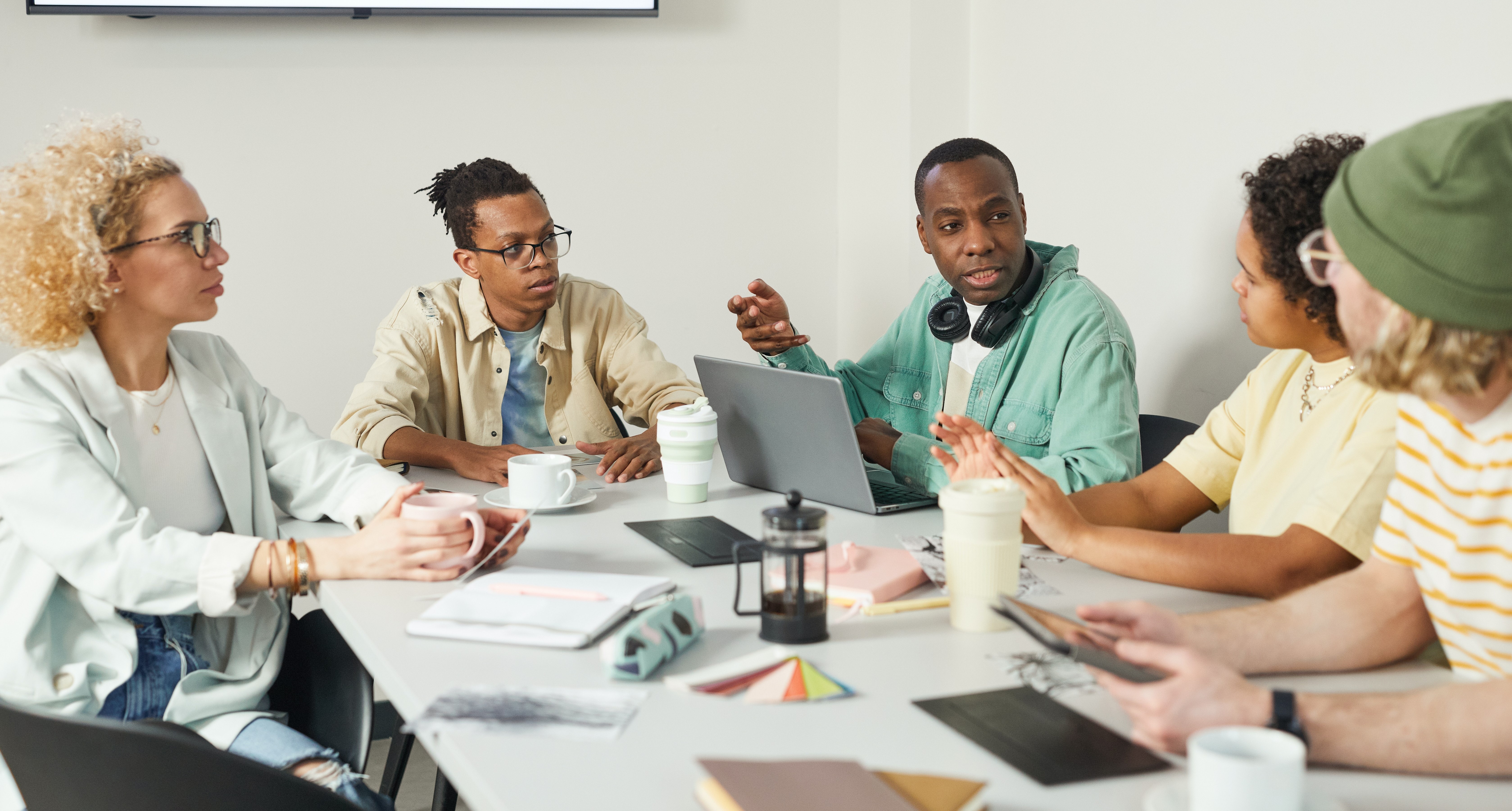 A group of people gathered at a table engaged in discussion.